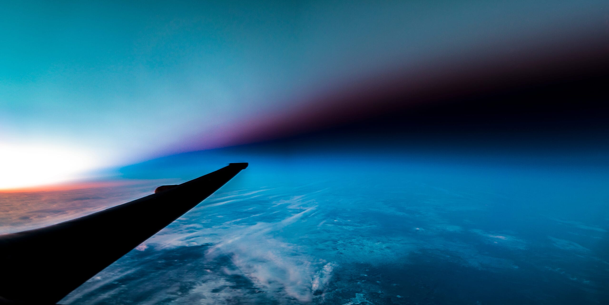 u-2 spyplane flies through the terminator line between light and dark at sunset