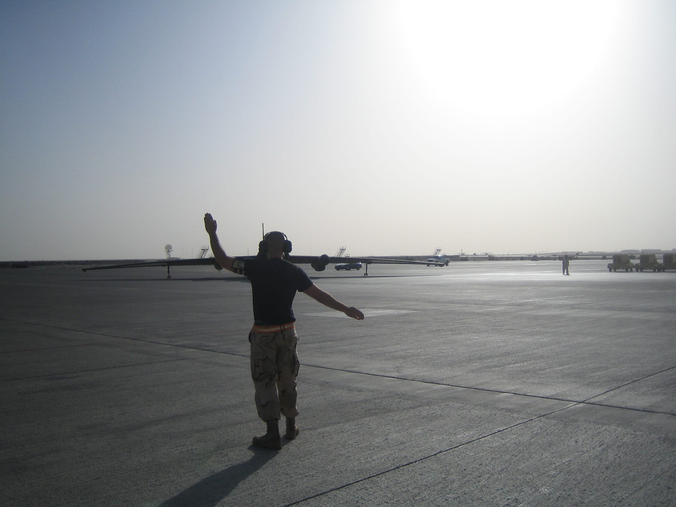 The marshaller guides the plane into parking