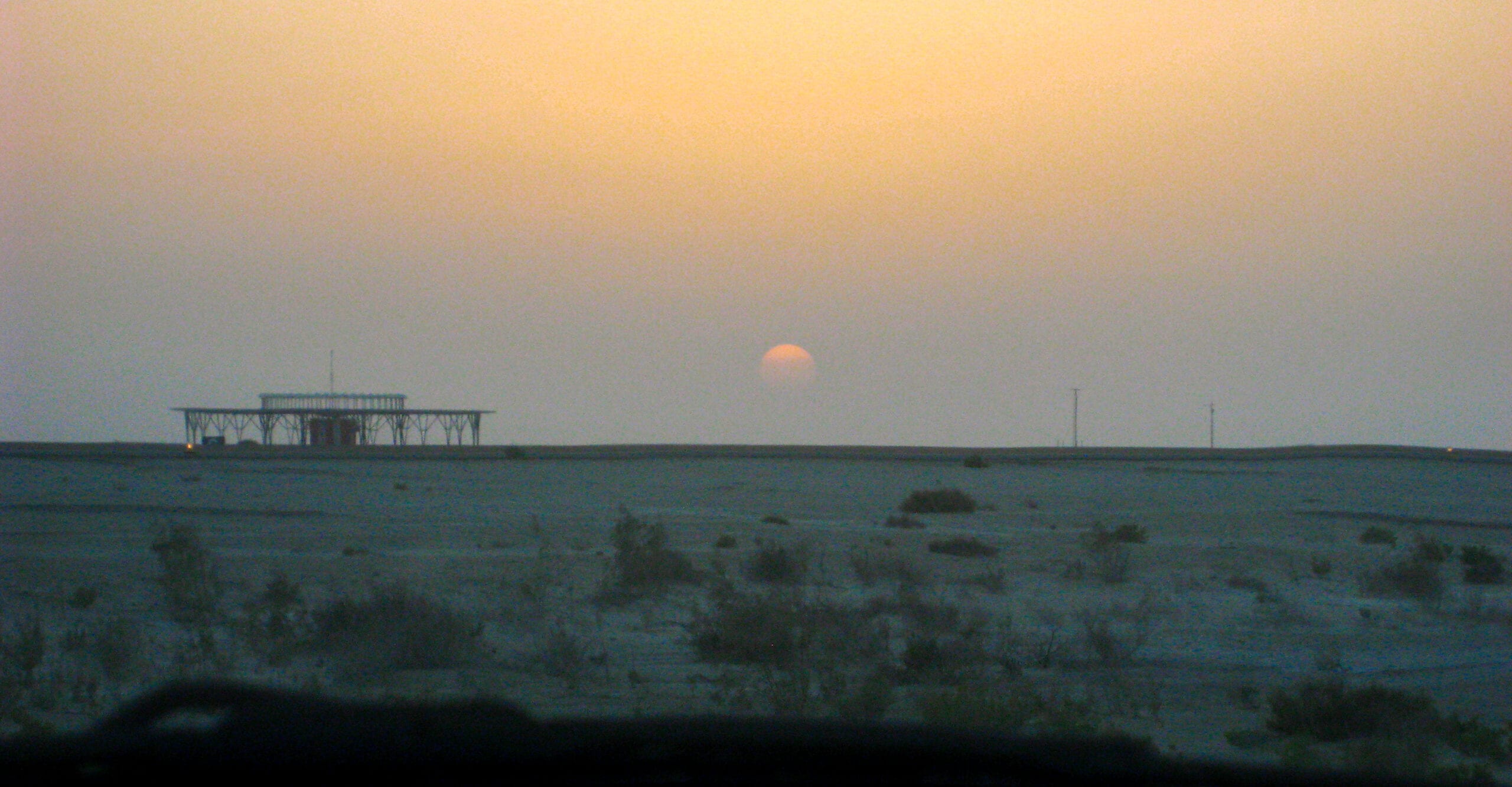 sun setting over the desert landscape